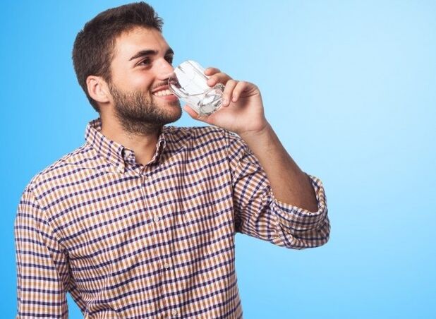 Un uomo beve una bevanda che influisce sulla potenza